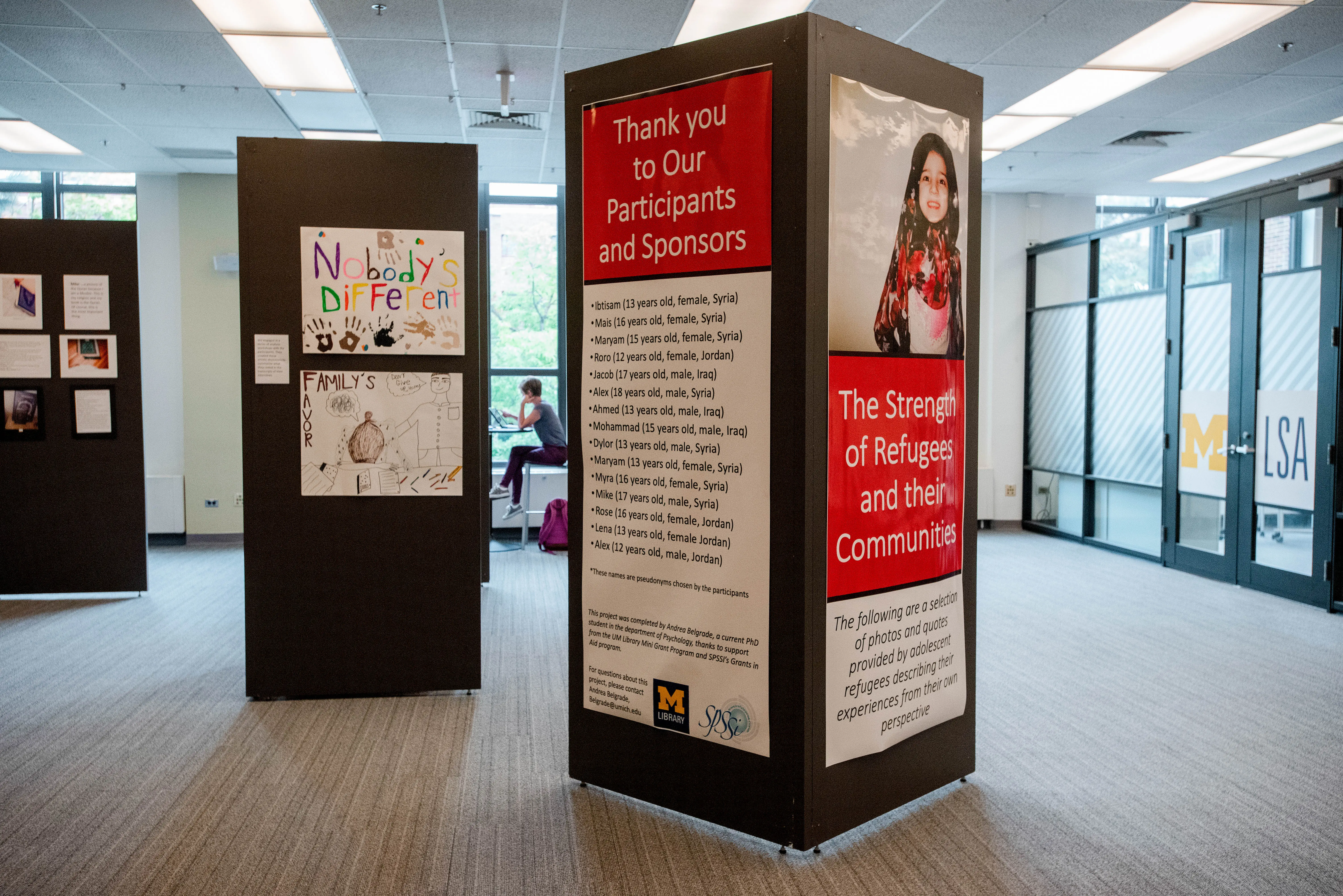 Hatcher Gallery Exhibit Space with photos and art on movable walls.