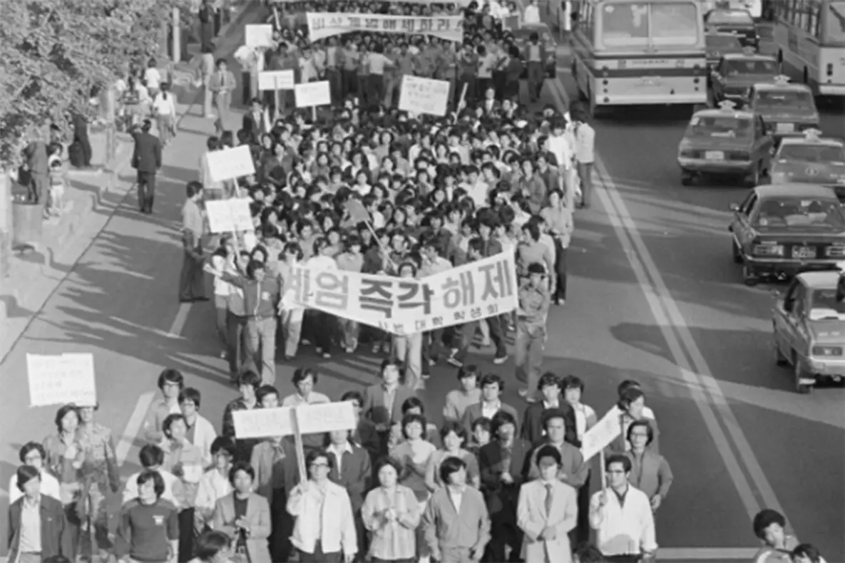 Demonstrators carry banners demanding "Lift Martial Law Immediately" (계엄 즉각 해제).