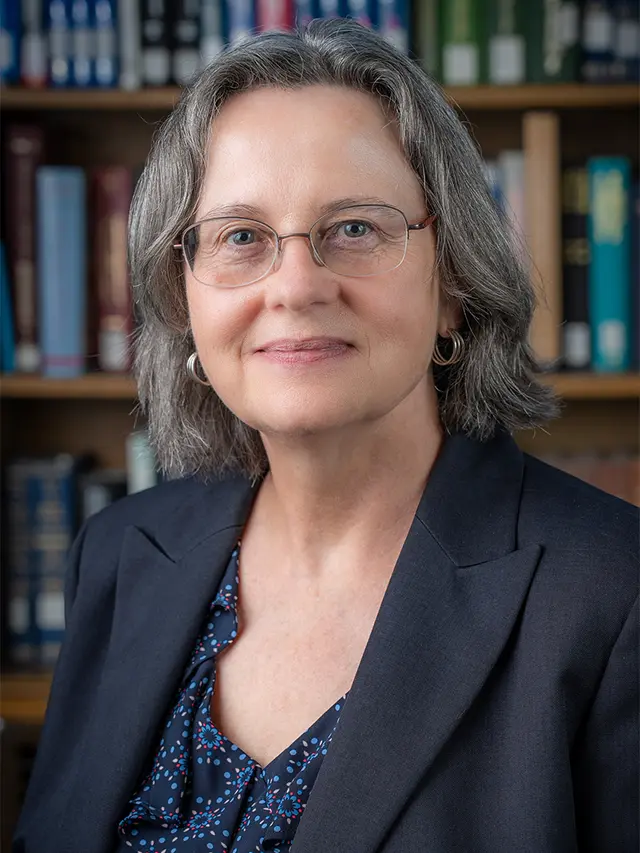 photo showing a white woman wearing a jacket and blouse